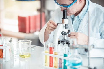 Fototapeta premium Scientist looking through microscope in laboratory with copy space using as background science, medical , education, biology, chemistry concept.