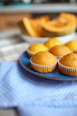 Pumpkin muffins on blue plate on table, homemade bakery