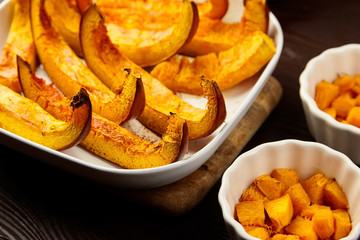 Slices of baked pumpkin in white ceramic bowl