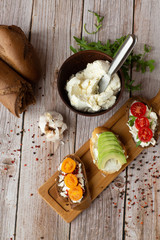 Bruschettas with vegetables. Start dishes with cherry tomatoes, avocado, cream cheese. Delicious snacks with chorizo and baked tomatoes. Food composition, tasty italian meal.