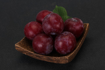 Plum heap in the wooden basket