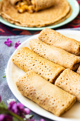 Crepes rolls with apples fruits or thin sweet pancakes. Homemade vegan dessert.