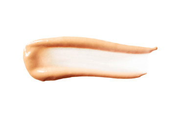 Beige liquid shiny creamy foundation smear stroke isolated on white background. BB cream or CC cream sample. Concealer smudge, above. Cosmetic fluid corrector smooth, macro