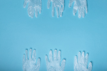 Naklejka premium Whitte surgical gloves isolated on the blue background. Concept protect against infection or contamination