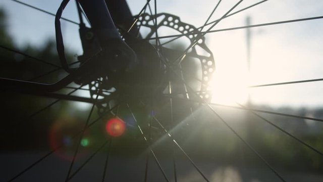 Close up of bicycle front wheel disc Brake with lensflare