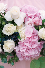 Original wedding floristics closeup. The wedding flower bouquet is supplemented with rose hortensia, roses and greenery. Floral background