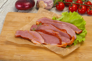 Sliced smoked duck breast served salad