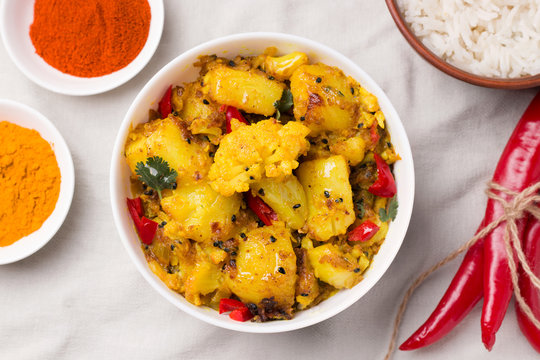 Indian traditional cuisine. Gobi aloo is a vegetarian dish of cauliflower and potato next to the ingredients.