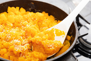 Pumpkin porridge with sesame seeds. View of pumpkin porridge in a pan.