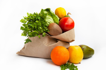 Set of food products on a white background. A paper bag delivers a quarantine food crisis. Food Delivery, Donation, Coronavirus. Fresh vegetables, fruits. Soft focus.