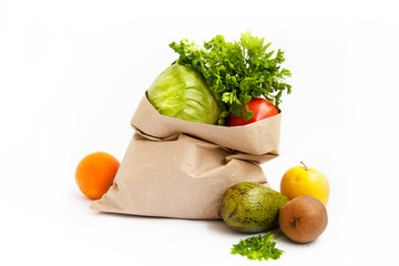 Set of food products on a white background. A paper bag delivers a quarantine food crisis. Food Delivery, Donation, Coronavirus. Fresh vegetables, fruits. Soft focus.