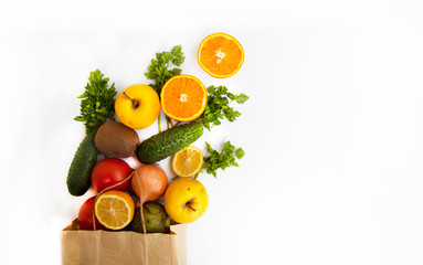 Set of food products on a white background. A paper bag delivers a quarantine food crisis. Food Delivery, Donation, Coronavirus. Fresh vegetables, fruits. Soft focus.