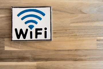 Wi Fi sign on wooden wall in corridor of modern building