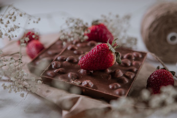 .Chocolate with hazelnuts and fresh strawberries. Sweet breakfast. Sweets. Sweet food. Organic fruits.