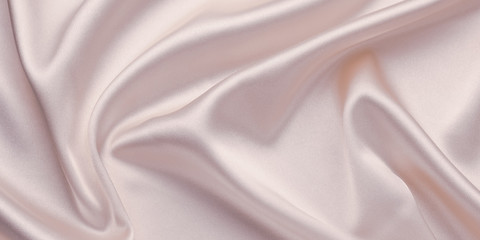 Silk pattern, waves of satin material, shiny texture, abstract pastel pink background, wallpaper with folds of textile, fabric.