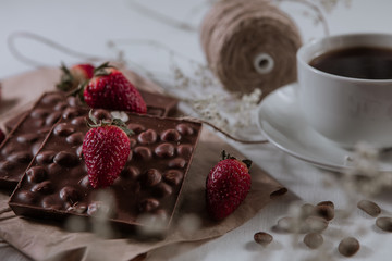 Chocolate with hazelnuts. Hot drink. Food concept. Food set. Coffee beans. Tasty breakfast. Strawberries with chocolate.