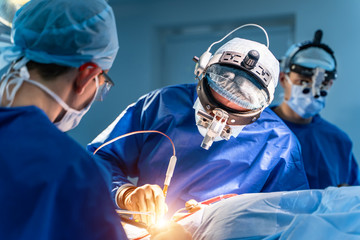 Group of surgeons in operating room. Modern equipment in operating room.