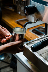 Steaming the milk for a latte, espresso machine