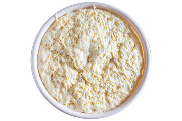View of the dough kneaded in a plastic bowl. View from above. Isolated on a white background.