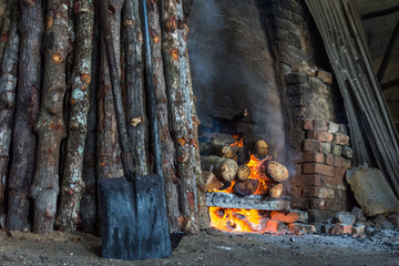 traditional charcoal kiln with charcoal under production with mangrove (Rhizophora sp) wood