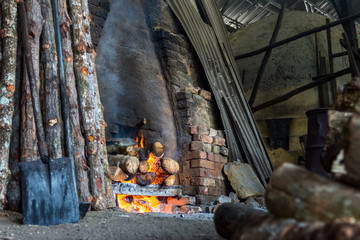 traditional charcoal kiln with charcoal under production with mangrove (Rhizophora sp) wood