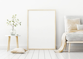 Poster mockup with vertical frame standing on floor in living room interior with sofa, beige pillow and branch in glass vase on empty white wall background. 3D rendering, illustration. - obrazy, fototapety, plakaty