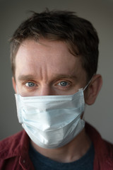 man in medical mask looking at camera