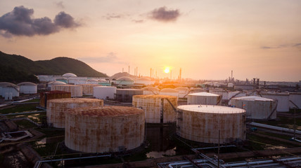 Fototapeta premium Aerial view of A lot of Oil depot Gas storage tank for send follow pipe to oil refinery tower on sunrise back ground.
