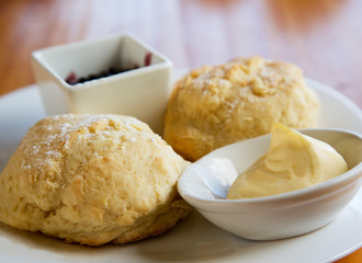 Biscuits sweetened with jam, powdered sugar, and sweet whipped butter