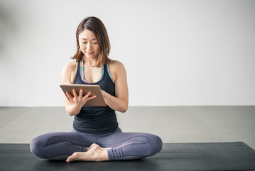 Woman watching yoga online tutorial.