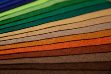 multicolored felt close up laid out by colors in expanded form	
