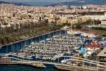 Fototapeta na wymiar Grand View of port of Barcelona on the Mediterranean with view of Barcelona city, Catalonia's largest port