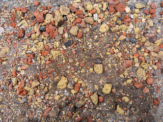 Texture of broken brick and stones, construction debris on the ground.