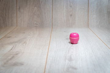 Obraz na płótnie Canvas Pink lipstick in box on wooden background