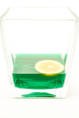 glass of green liquid with lemon slice