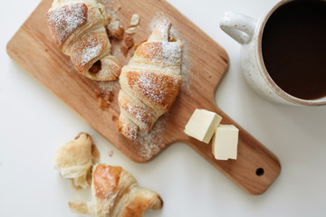 Stuffed homemade puff with powdered sugar, hot chocolate on white table - 345998191