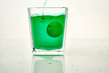 cocktail pouring into glass with lemon