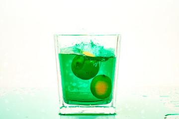 green cocktail with lemons