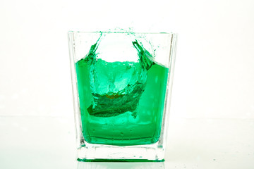 glass of green liquid with lemon