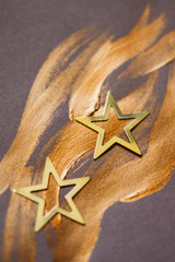 Two golden stars on a brush stroke in bronze shimmering colour; Christmas, Advent