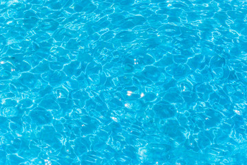 Fototapeta na wymiar Swimming pool water surface in the sunlight texture background and wallpaper