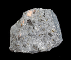 Rock sample interspersed with Leucite isolated on white background. Mineral of volcanic origin