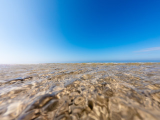 Fototapeta na wymiar Shot from the water on a beach in the sea