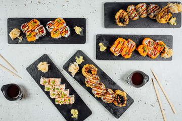 Top view on Set of sushi rolls with ginger soy sauce and Wasabi