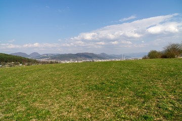 Sunrise and sunset, beautiful clouds over the meadow, hills and buildings in the town. Slovakia
