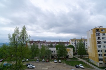 Sunrise and sunset, beautiful clouds over the meadow, hills and buildings in the town. Slovakia