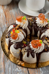 Orthodox easter cake with chocolate, raisins and nuts, decorated with chocolate icing and buttercream