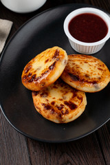 Close up of yummy traditional russian cottage cheese fritters with jam