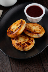 Close up of yummy traditional russian cottage cheese fritters with jam