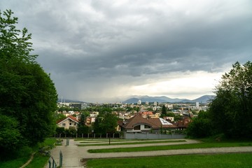 Sunrise and sunset, beautiful clouds over the meadow, hills and buildings in the town. Slovakia